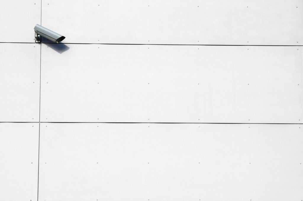 Security camera on concrete wall
