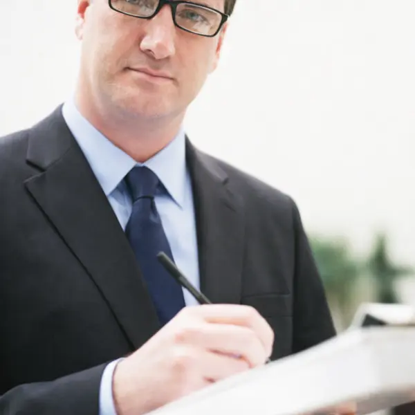 Executive man in Downey taking notes to Book consultation