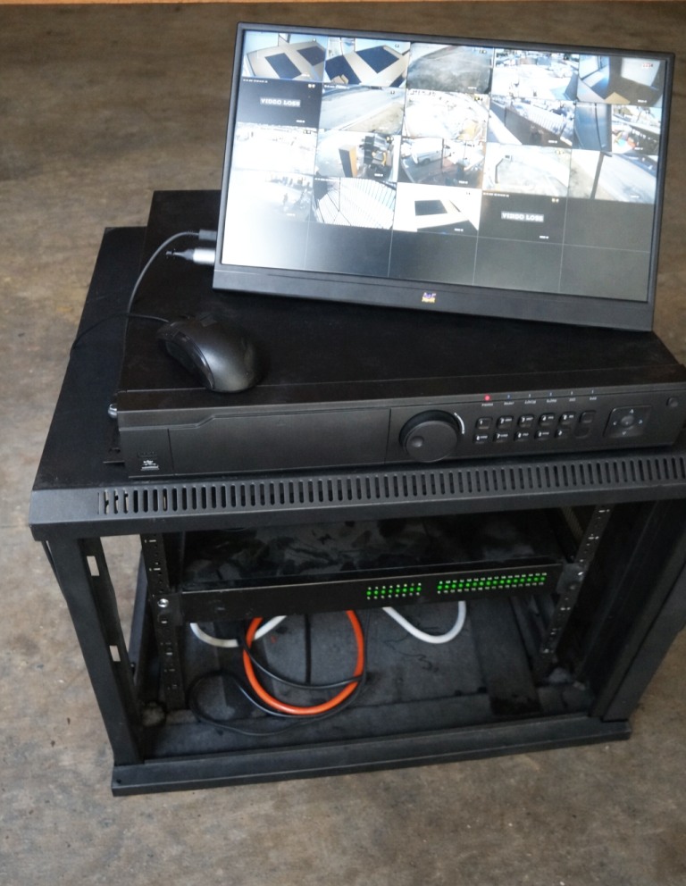 Security camera system with DVR and monitor displaying live camera feeds