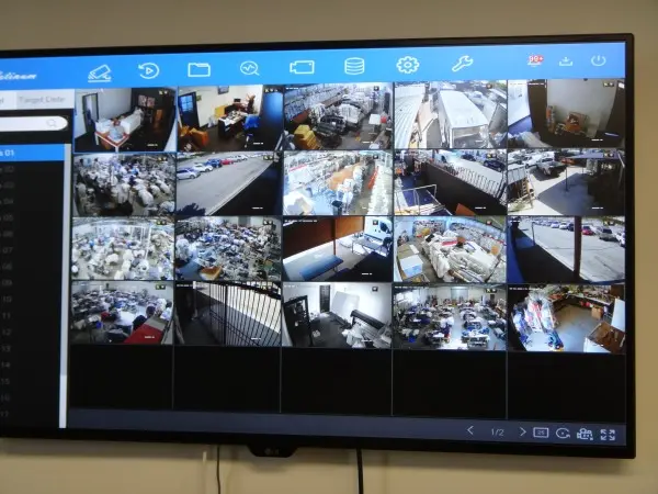 Security camera system live view monitor showing multiple camera feeds in warehouse