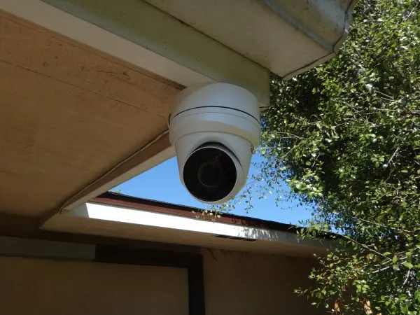 4K outdoor dome security camera installed under roof eave during residential CCTV installation in Lakewood.