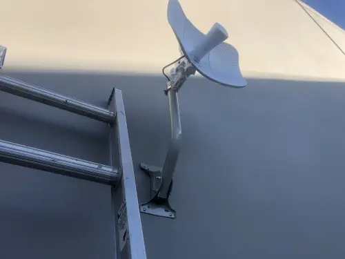 Wireless bridge mounted on commercial building wall for network extension in City of Industry, CA