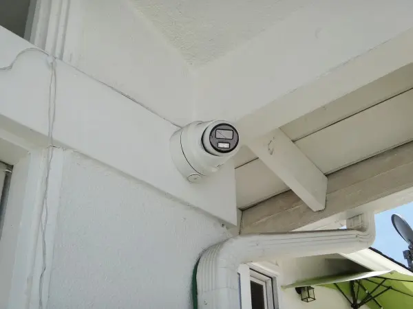 Backyard security camera side view showing installed residential surveillance coverage