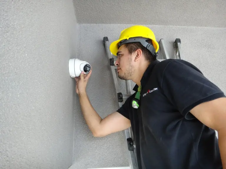 Technician adjusting a security camera during a residential security camera installation in Brea CA