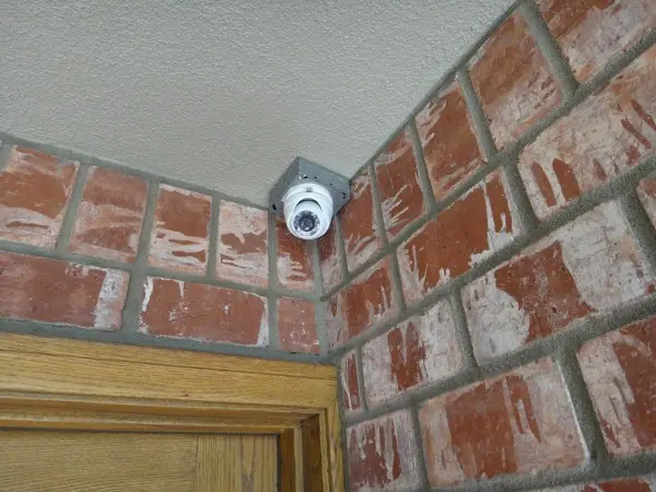 Outdoor security camera near entry door during maintenance and image troubleshooting service in Long Beach CA