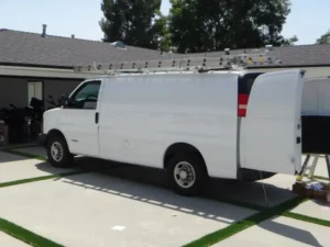 Security camera installation service van parked at residential property during installation