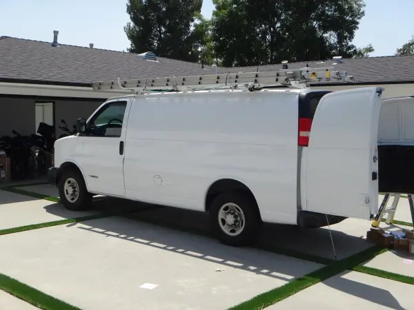 Security camera installation service van parked at residential property during installation