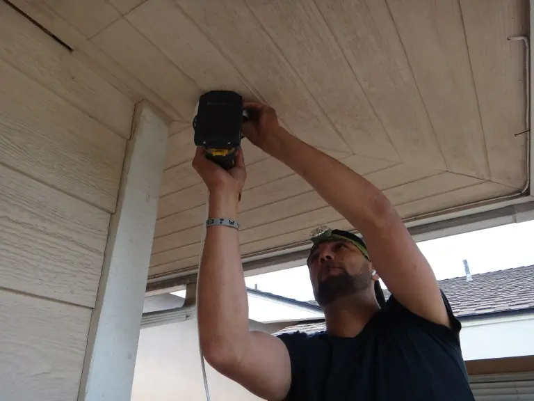 Technician performing a security camera system upgrade at a residential property in Brea CA