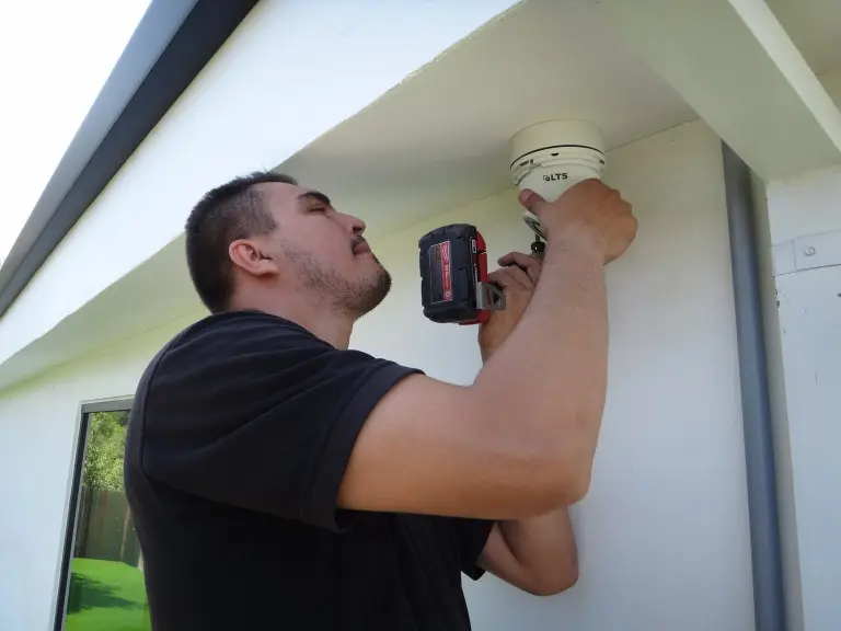Security camera installer adjusting dome camera
