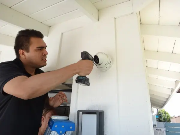 Technician installing residential security camera during security camera installation project in La Habra CA