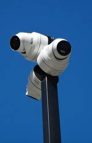 Three 4K security cameras mounted on a post during a security camera installation in Long Beach, California.