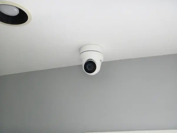 Indoor security camera mounted on a ceiling corner for residential surveillance