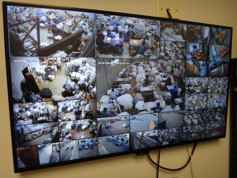 Commercial security camera system monitoring warehouse operations with multiple camera views