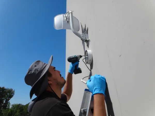 nstaller securing a weatherproof junction box
