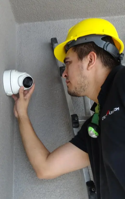 Protection4Less technician installing a turret security camera on a residential property in Covina CA