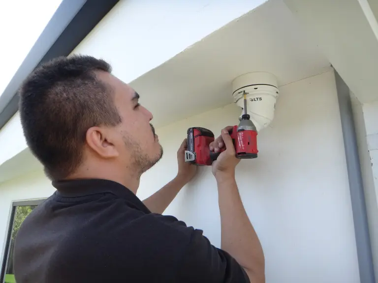 Professional security camera installation in Garden Grove CA with technician mounting an outdoor surveillance camera