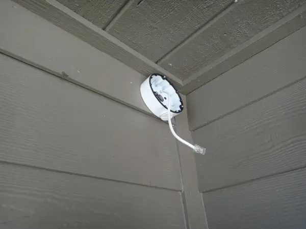 Security camera junction box mounted on exterior wall