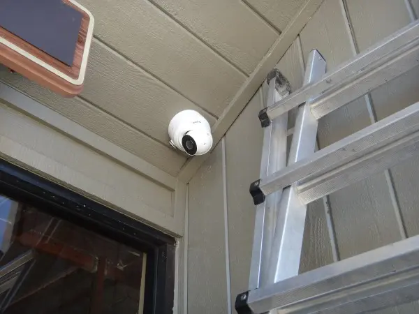 Commercial security camera installed to monitored back door a warehouse