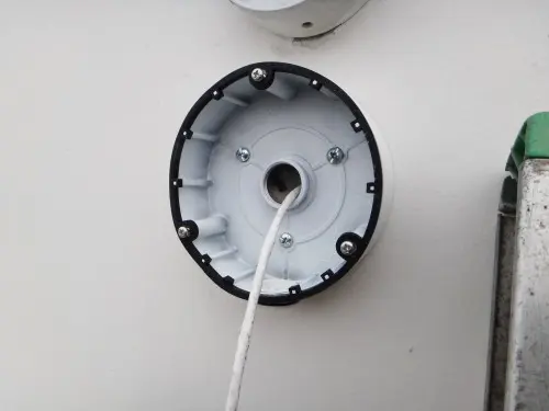 Close-up of a weatherproof junction box prepared for a commercial security camera installation