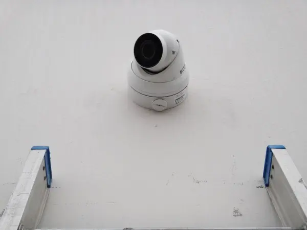 Commercial security camera professionally mounted on a weatherproof junction box at a business in Santa Fe Springs, CA.