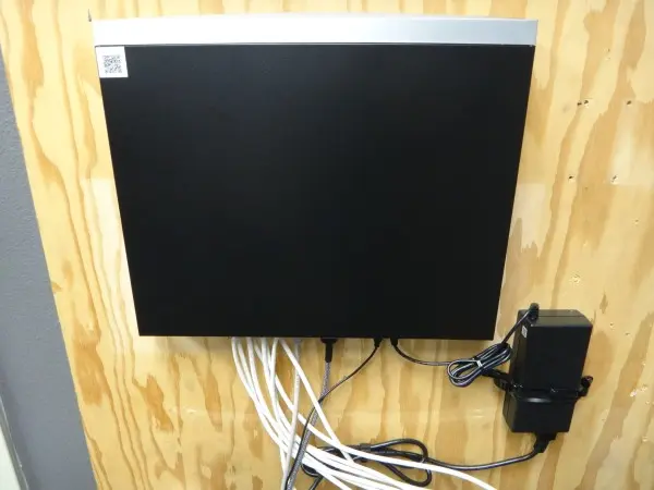 Commercial network video recorder (NVR) installed with connected network cables and power supply in Santa Fe Springs, CA.