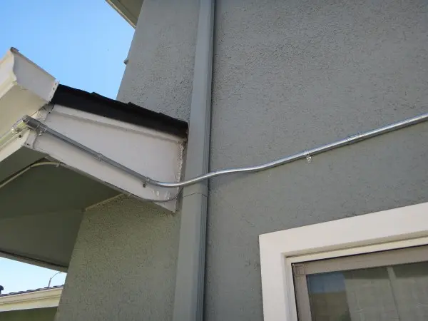 Custom electrical conduit routing installed around an exterior obstruction during a residential security camera installation in Rowland Heights CA.