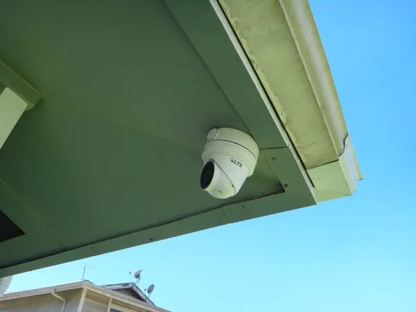 Outdoor 4K security camera professionally installed under the roof eave with concealed wiring