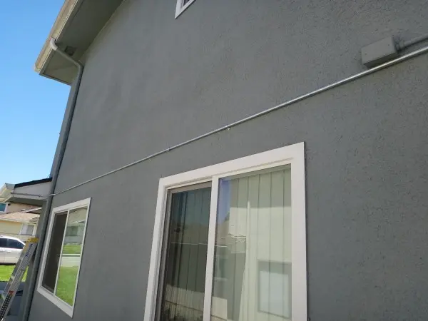 Protective electrical conduit installed for security camera wiring during a residential security camera installation