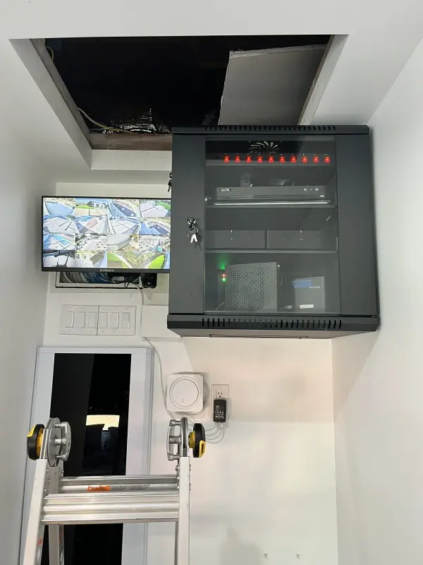 Professional security camera equipment rack with NVR and live monitoring display