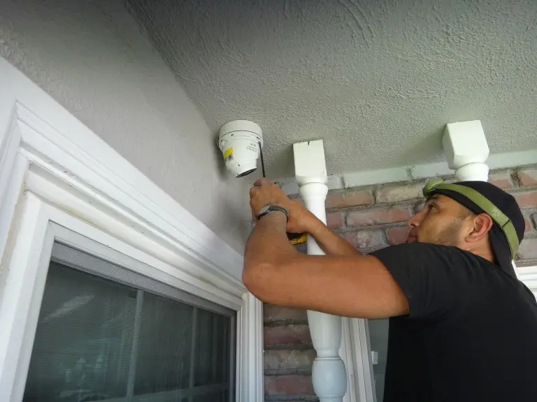 Technician installing a 4K security camera during a residential security camera installation in Fullerton, CA