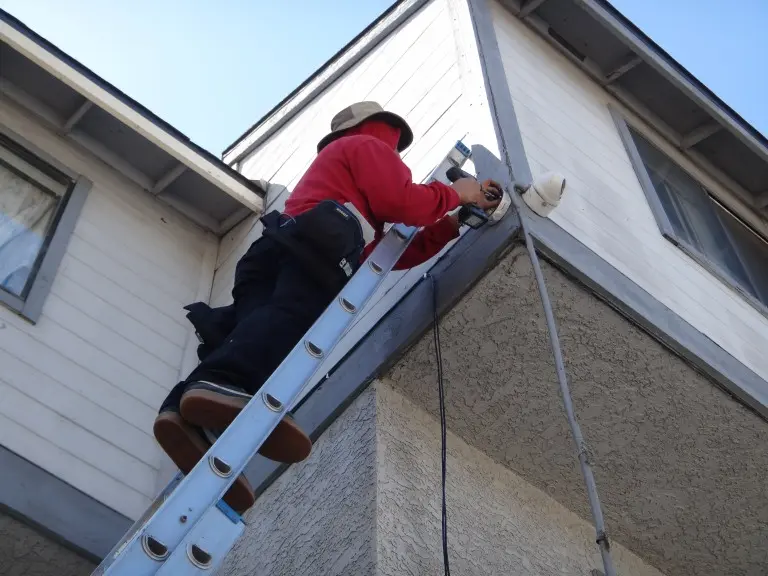 Technician installing a 4K security camera at a gated community in Azusa, CA.