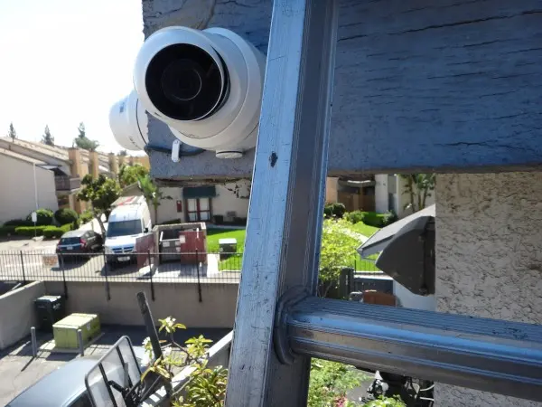 Professional installation of a 4K security camera using a ladder