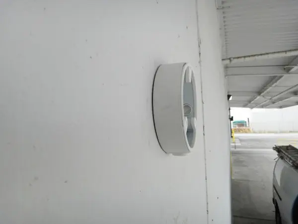 Weatherproof security camera junction box installed on a commercial warehouse wall in Paramount, CA.