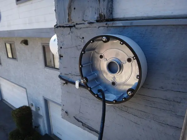 Security camera mounting base being installed