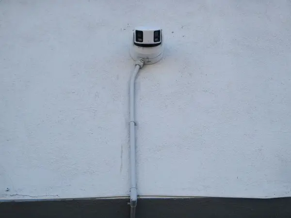 180-degree security camera installed with exterior conduit on apartment building in South Gate, CA