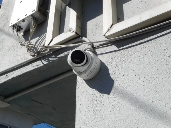 4K security camera installed with exterior conduit on apartment building