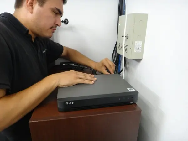 Technitian installing a new NVR