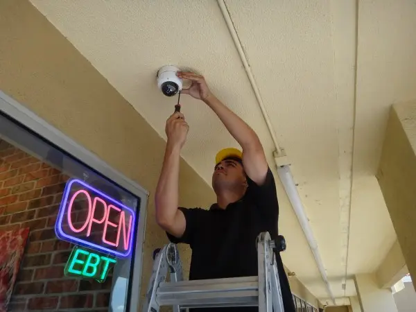 Technician installing a security camera at a business in Hacienda Heights, CA