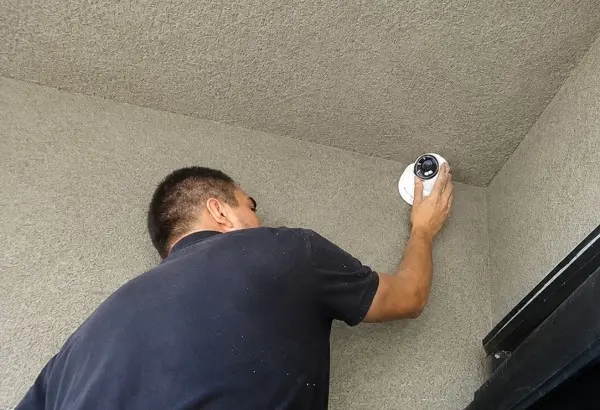 Technician installing two-way audio security camera at home entrance in La Mirada, CA
