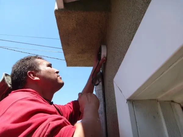 Technician installing junction box for security camera in Pico Rivera, CA
