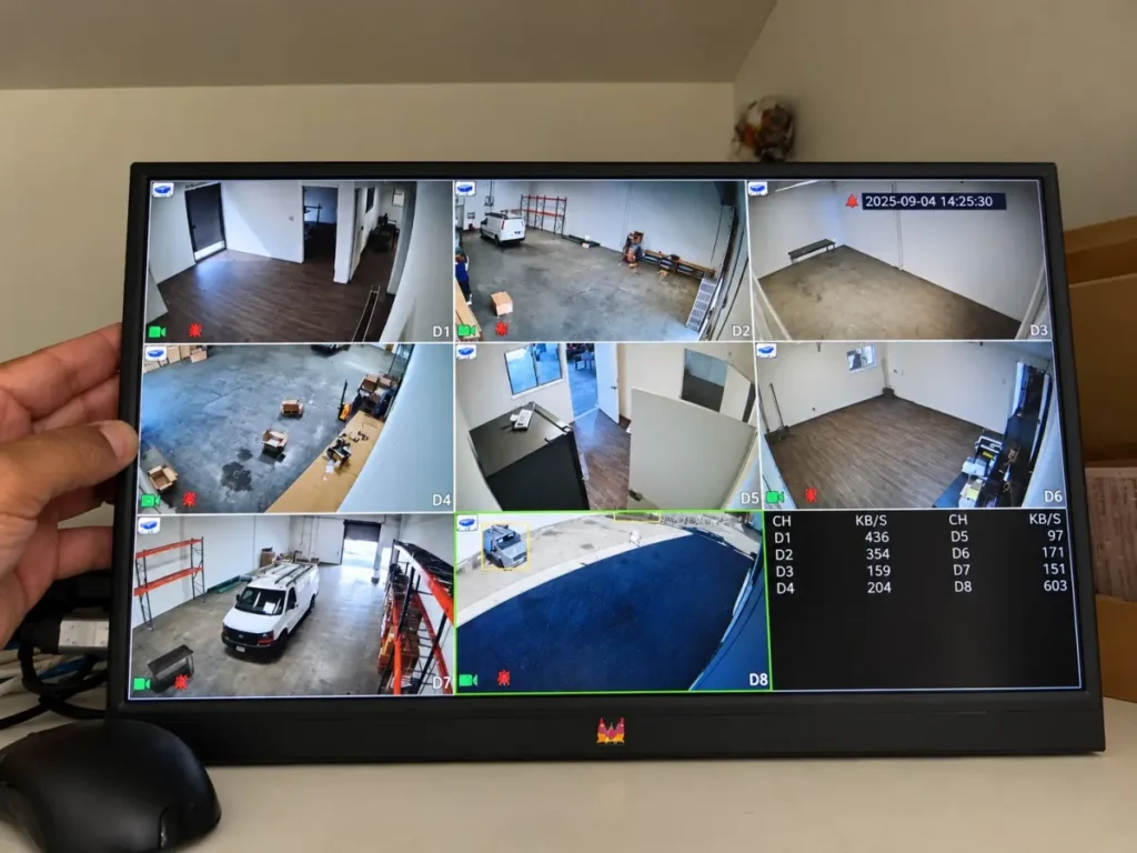 Security camera system monitor showing eight camera views at a Gardena warehouse