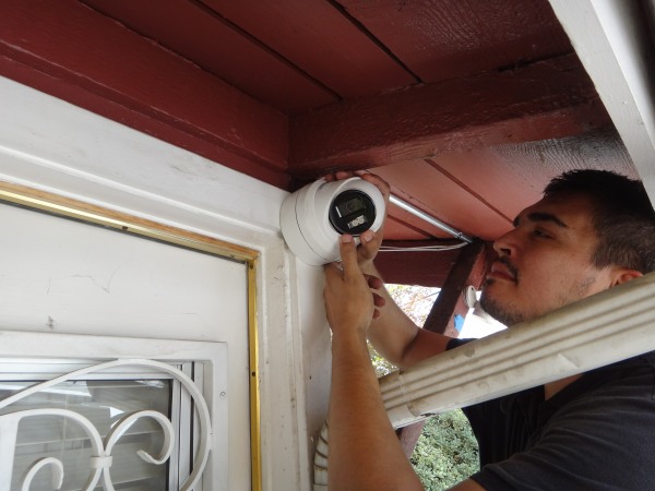Technician installing a security camera at a home in Whittier, CA